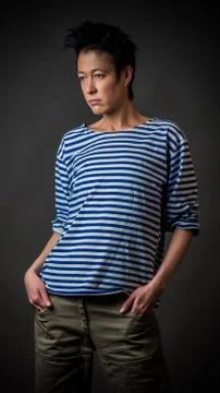 Androgynous character in a striped vest Stock Photos