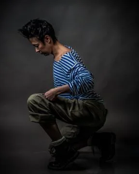 Androgynous character in a striped vest Stock Photos