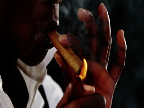 Androgynous man lighting a cigar Video stock 78606087
