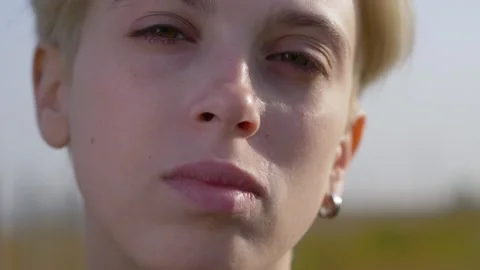 Androgynous model portrait, close up of a blonde young lesbian woman Stock Footage 140924942