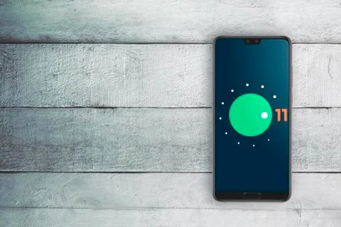 Android 11 operating system logo on a mobile phone screen. Stock Photos