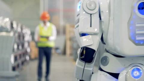 Android and factory worker are meeting and communicating. 4K. Video stock 89225151