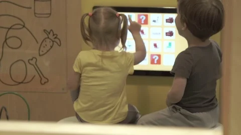 Android Device baby with the tablet with a large screen plays and laughs. Tablet Stock Footage 78982504