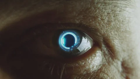 Android eye with a glowing cybernetic iris staring at the camera. Macro, close Stock Footage 246058385