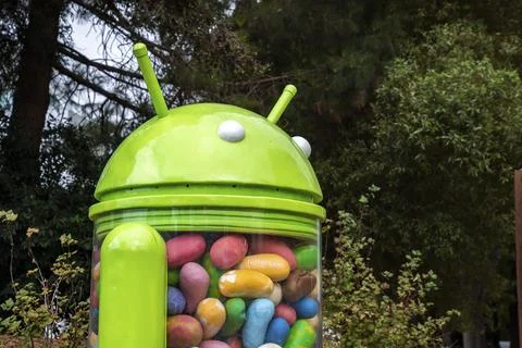 Android jelly bean statue with trees in background in garden at google campus Stock Photos