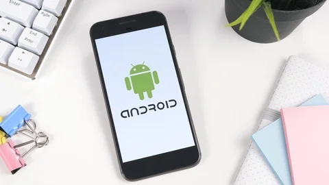 Android Logo on a Smartphone Screen on a Desk Stock Footage 88681653