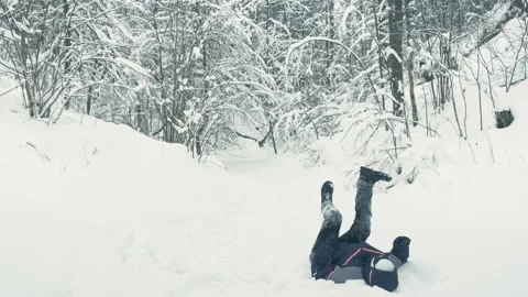 Android walks in snow. He falls, stands up. Parody of robots Stock Footage 147765369