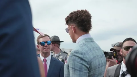 Andy Beshear and Patrick Mahomes talking before Kentucky Derby in paddock Stock Footage 242057967