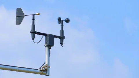 Anemometer and wind vane against blue sky on windy day Stock Footage 128838066