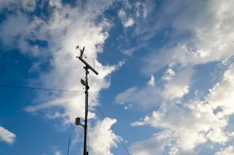 Anemometer and wind vane on blue sky Stock Photos