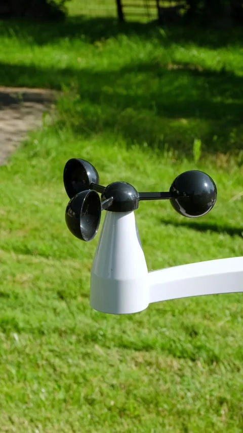 Anemometer measuring wind speed outdoors on a green grass background. Weather Stock Footage 346215781