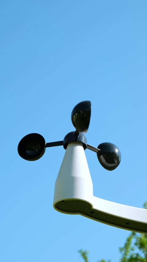 An Anemometer measuring wind speed outdoors on a blue sky background. Weather Stock Footage 346549916