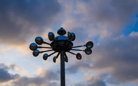 Anemometer or wind speed meter silhouetted against cloudy background. Stock Photos