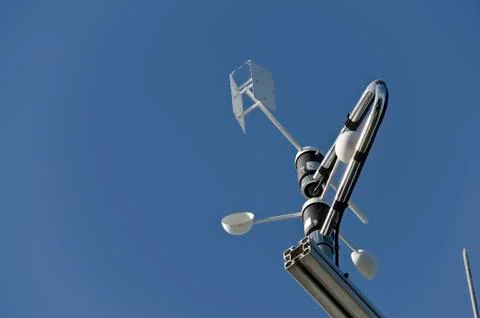 Anemometer or wind vane on a blue sky Stock Photos