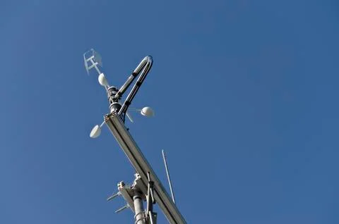 Anemometer or wind vane on a blue sky Stock Photos