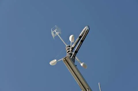 Anemometer or wind vane on a blue sky Stock Photos