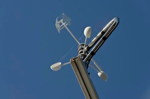 Anemometer or wind vane on a blue sky Stock Photos