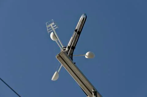 Anemometer or wind vane on a blue sky Stock Photos