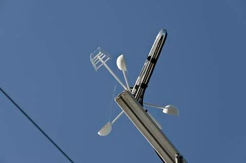 Anemometer or wind vane on a blue sky Stock Photos