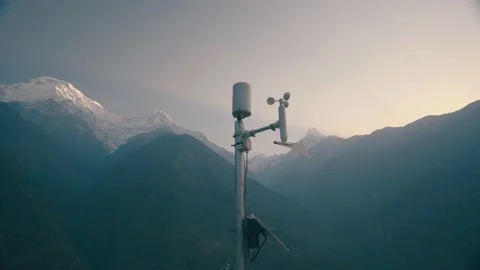 Anemometer Weather station with Huge Mountain Covered Snow in Morning Stock Footage 154017331