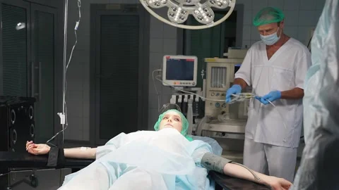 Anesthesiologist using surgical equipment and instruments to prepare female Video stock 147322385