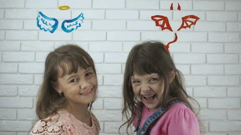 Angel and the devil. Good and evil child. Stock Footage 100128313