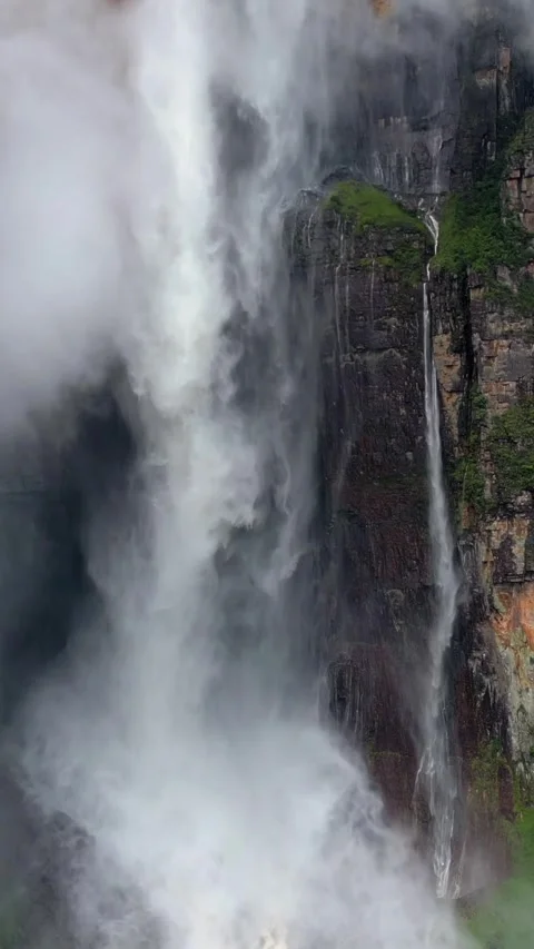 Angel Falls waterfall through the clouds. Close up of a huge flow of water falls Stock Footage 303739691