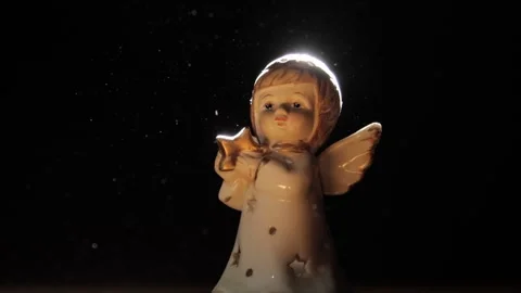 Angel figurine in a ray of light 库存影片 258837535