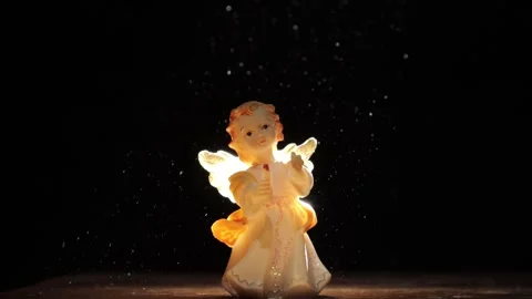 Angel figurine in a ray of light 库存影片 258837537