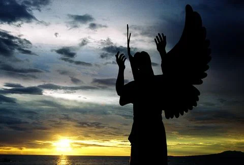 Angel in front on a sunset 写真素材