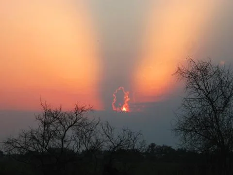 Angel-Like Sunset Light in Storm Clouds Over the Coastline Stock Photos
