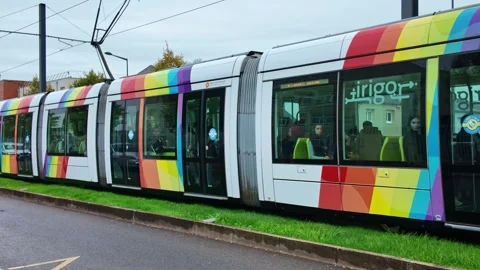 Angers Tram Passing with Rainbow Design on a Cloudy Day Stock Footage 319644232