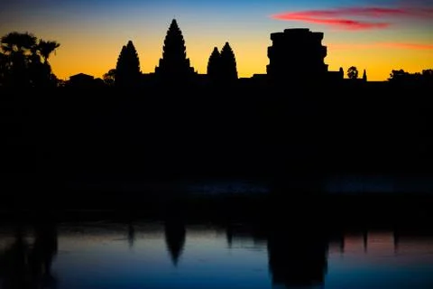 Angkor Wat dramatic sky at dawn main facade silhouette reflection on water po Stock Photos