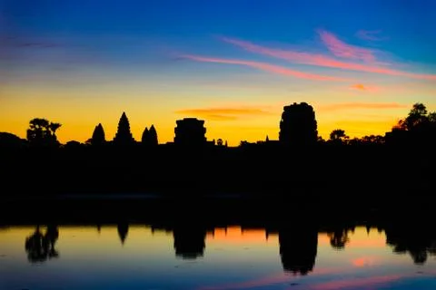 Angkor Wat dramatic sky at dawn main facade silhouette reflection on water po Stock Photos
