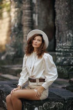 Angkor Wat Ta Som -Stylish Woman In Hat Sitting On Ancient Temple Stones Stock Photos