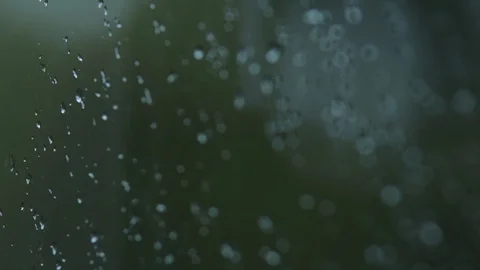 Angle close up of rain drops on glass window with forest in background Stock Footage 92588528