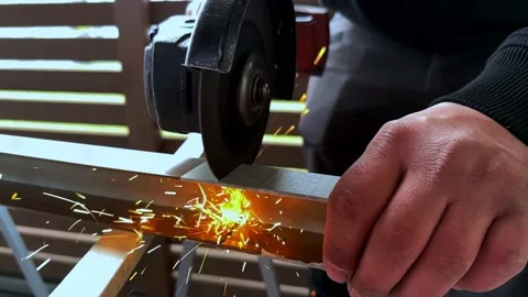 Angle Grinder Causing Sparks While Being Used to Cut Metal Stockbeeldmateriaal 234509537