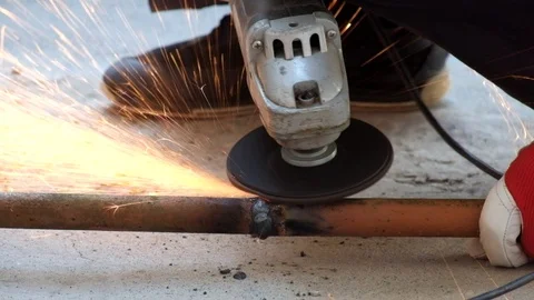 Angle grinder cleans the weld on the pipe Stock Footage 89137105