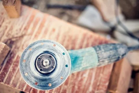 Angle grinder on construction site for cutting bricks, debris. Tools and bricks Stock Photos