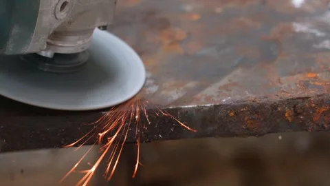 Angle grinder creating bright sparks while cutting metal Stock Footage 327401637