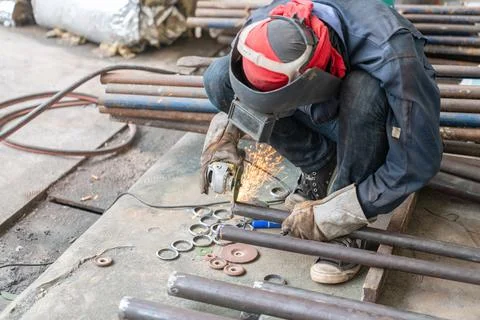 Angle grinder cut pipe end of boiler. Stock Photos