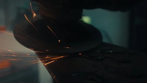Angle grinder cutting metal with explosive sparks macro detail Stock Footage 332047825
