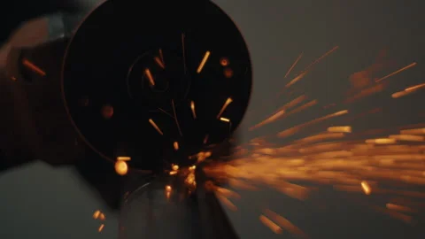 Angle grinder cutting metal pipe showering sparks in slow motion Stock Footage 331696030