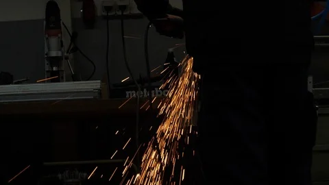 Angle Grinder cutting stainless Steel in Slowmotion 4K Stock Footage 105013997