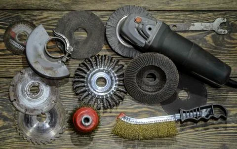 Angle grinder with different discs and tools on the old wooden background Stock Photos
