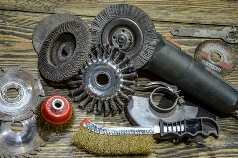 Angle grinder with different discs and tools on the old wooden background Stock Photos