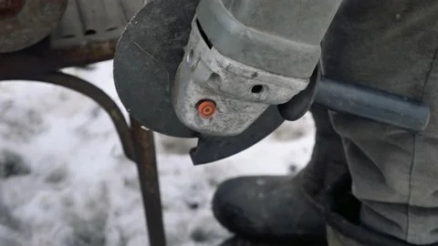 Angle grinder in the hands of a man Stock Footage 133200937