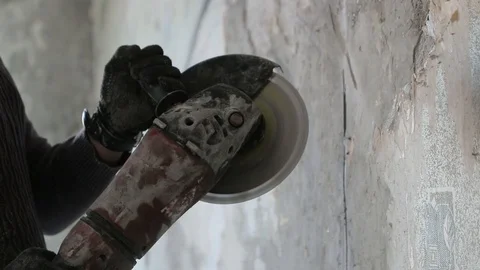 Angle grinder in the hands of a worker. Slow motion video Stock Footage 89049609