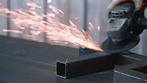 Angle grinder, iron cutting process mechanic's workshop Stock Footage 73603146