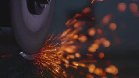Angle grinder machine sharpens a steel impact tool. Sparks fly. Close-up of Stock Footage 319060610